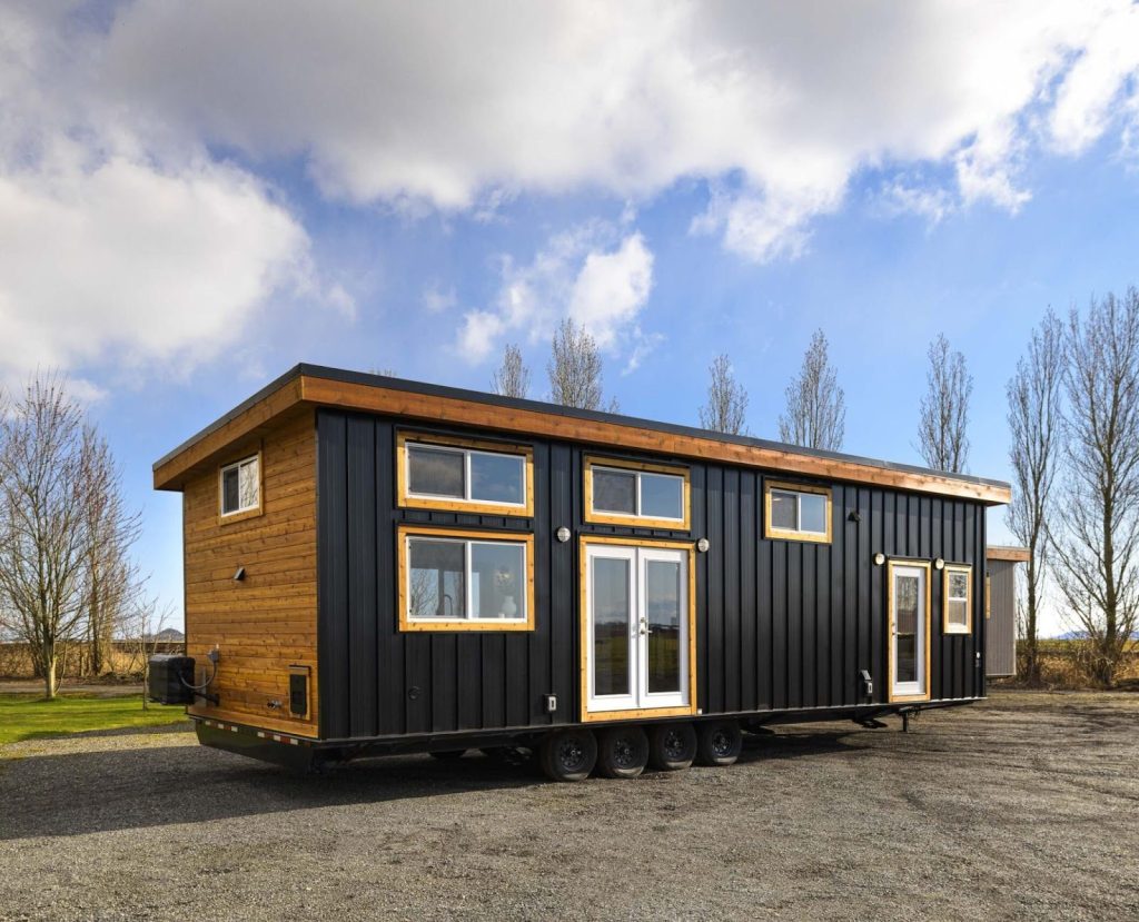 Cozy tiny home with modern kitchen, loft bed, and affordable compact design.
